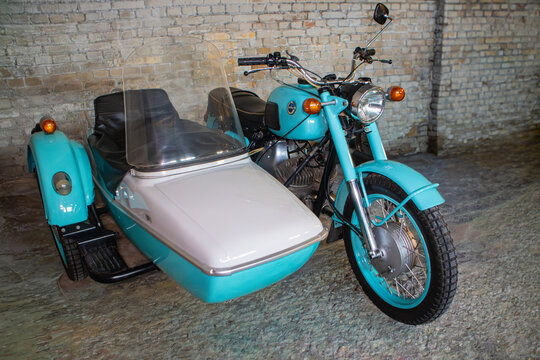 Vintage motorcycle with sidecar parked indoors