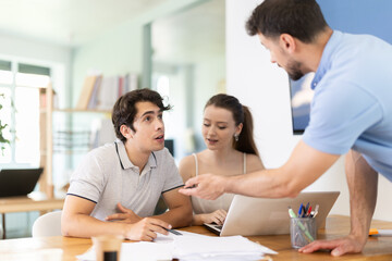 Fototapeta premium Three office employees read and process documents. Familiarization with contract, business correspondence, letter of claim, employment contract