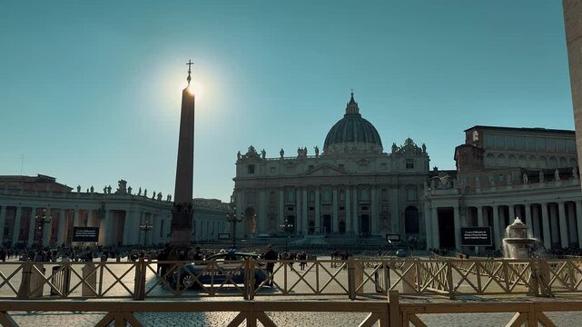 A panning shot of the impressive St. Peter's Square Colonnade in Vatican City, showing the giant columns and tourists strolling through the majestic covered architectural passage.
