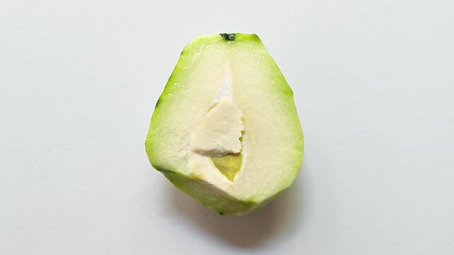 Fresh half chayote Sechium edule squash isolated on white background