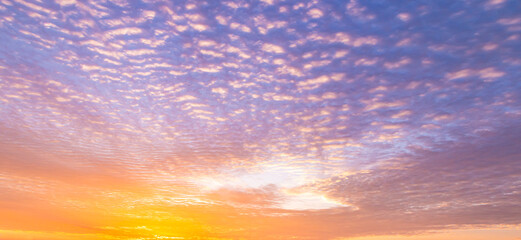 Fototapeta premium Beautiful vibrant twilight sky background with colorful soft pastel purple clouds for inspirational nature wallpaper panorama mockup