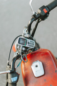 Creative life hack showing a button phone attached to a motorbike with a rubber band
