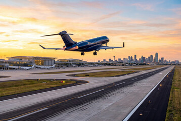 Fototapeta premium Dark blue private corporate jet taking off at dawn
