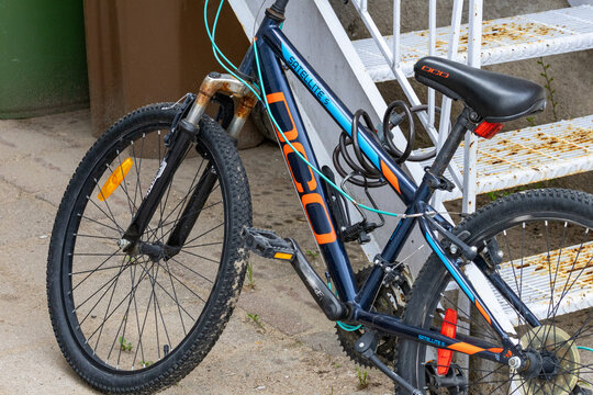La Tuque, Quebec, 16 May 2026 : A DCO Satellite  bicycle with a cable lock and rusty front forks is parked outdoors.