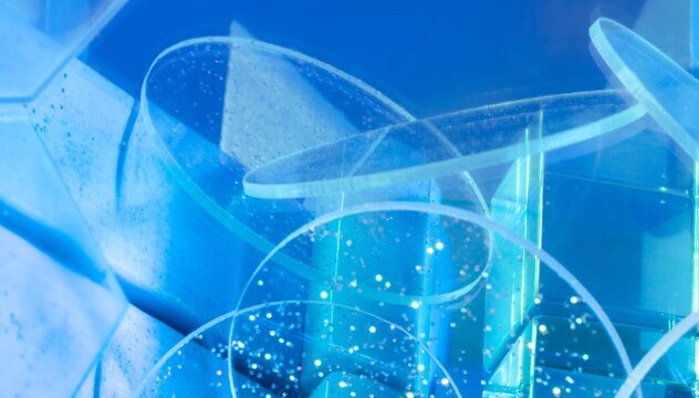 Abstract bright blue digital background with floating 3D polygons and light effects.