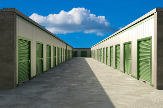 Self storage facility. Rows of rental storage units with roll up doors at commercial warehouse complex