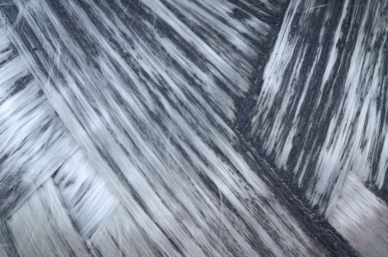 Close up of gray carbon fiber weave pattern for high tech manufacturing