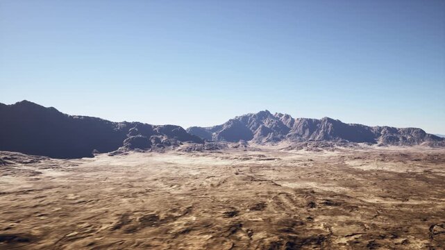 wide desert plain with distant mountains, sunlit rocky foreground and cracked earth, sparse scrub and ochre soil, clear blue sky with crisp light, jagged