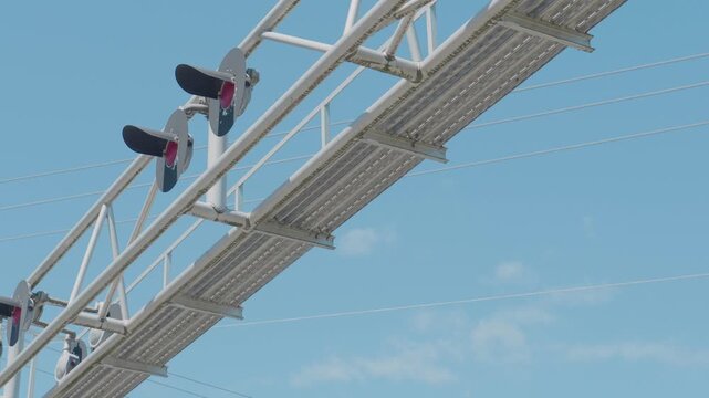 Railway signaling lights mounted on overhead metal truss gantry structure