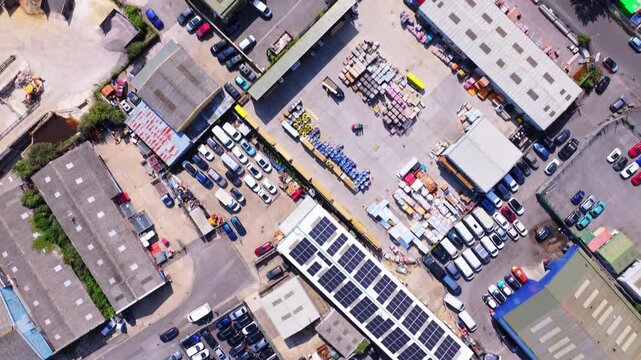 Aerial shot looking directly down on industrial estate with warehouses and vehicles. UK