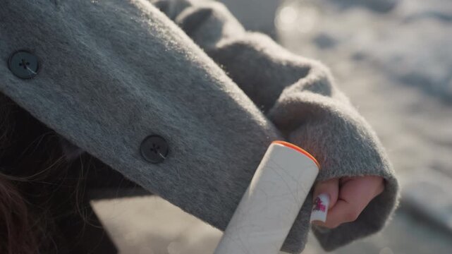 Hands clean routine. Detailed movement of fabric and button. Focus on grooming and textile textural features. Careful hand action highlighting fabric detail and clothing maintenance practices