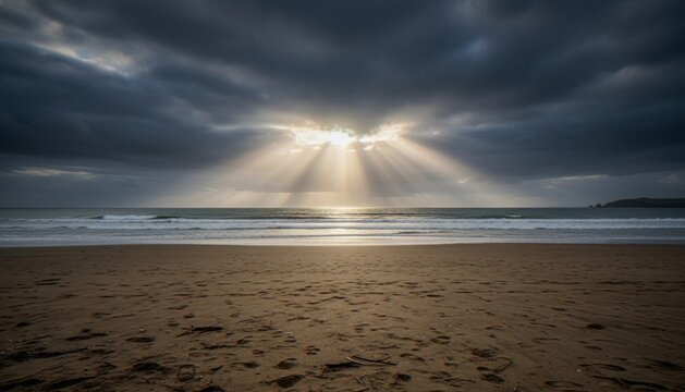 Dramatic sunset over the ocean with sun rays breaking through dark, moody storm clouds above a sandy beach.