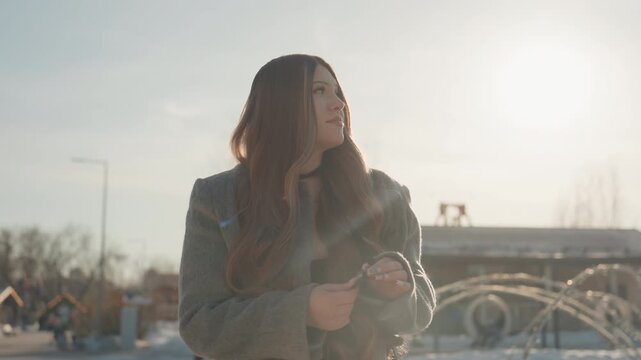 Reflective city scene with hopeful tone. Softly lit portrait showing optimism against fountain scenery. City plaza setting captured with gentle glow highlighting hopeful and reflective mood