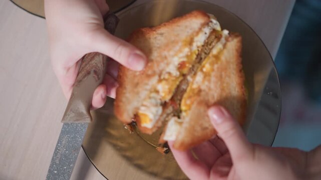 White woman opening toasted sandwich to reveal gooey cheese and runny yolk, handheld over plate, casual kitchen scene with crunchy crust and tempting filling, candid snack moment full of texture