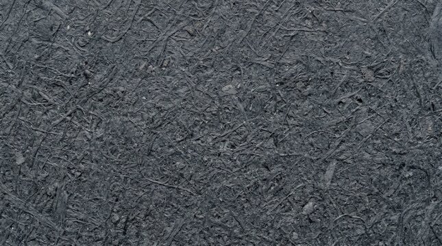 Charcoal grey fibrous industrial texture background with coarse interlocking pressed pulp material. Organic dark grey patterns for packaging design and corporate branding surfaces.