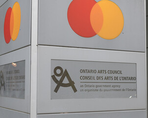 Naklejka premium exterior roadside pylon with business directory featuring Mastercard Canada and Ontario Arts Council located at 121 Bloor St E, Toronto