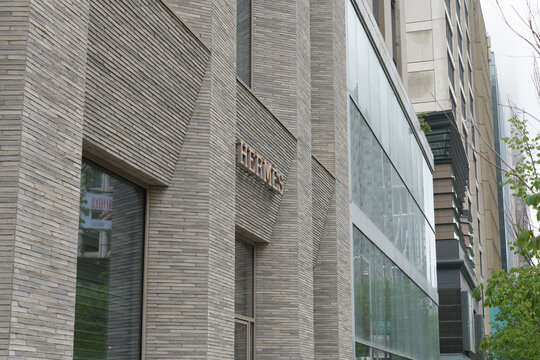 angle view of facade and sign of Herm&egrave;s, a luxury fashion accessories store, located at 100 Bloor St W, inside 10 Bellair Condominium, Toronto