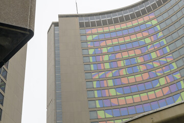 Naklejka premium Toronto City Hall (100 Queen St W), designed by architect Viljo Revell in the Modernist style, features twin curved concrete towers cradling a central, saucer-shaped council chamber