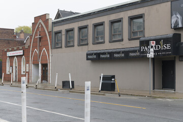 Naklejka premium wide view of Bloor Lansdowne Christian Fellowship and neighbor Club Paradise, an adult entertainment club, located at 1307-1313 Bloor St W, Toronto