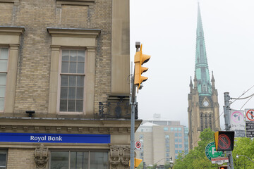 Naklejka premium RBC Royal Bank sign on the east facing wall of St Lawrence Hall (161 King St E at Jarvis St) with view of steeple at St James Cathedral Church, Toronto