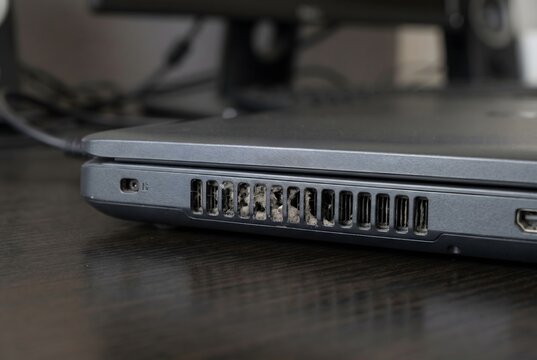 Full frame texture of laptop exhaust slit with heat-hardened dust clogging microscopic gap