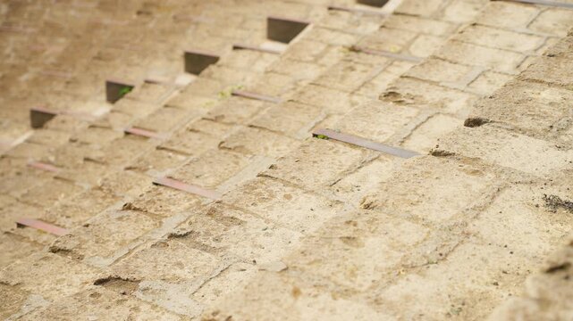 Close-up of ancient stone seating steps inside Pompeii&rsquo;s Roman theater, showing worn masonry blocks, rough texture, and preserved archaeological details.