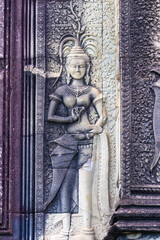 Fototapeta premium Apsara dancer carved in stone at Angkor Wat temple complex, Siem Reap, Cambodia. These celestial dancers are a common motif in Khmer art.