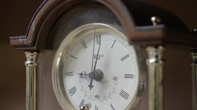 Close up angled shot of vintage antique mantel clock ticking time