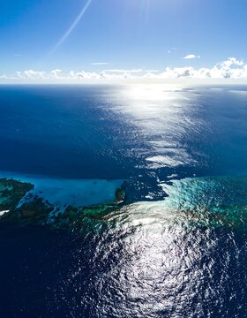 Serene ocean view with sunlight reflection.