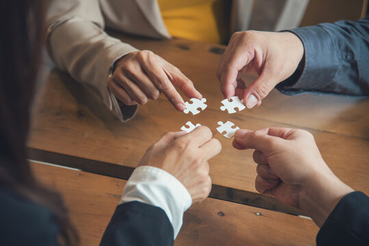 Business jigsaw puzzle connections strategy synergy team solution. Stakeholders business trusted communicate teams hands holding jigsaw puzzle synergy. Implement puzzle communication solve synergy