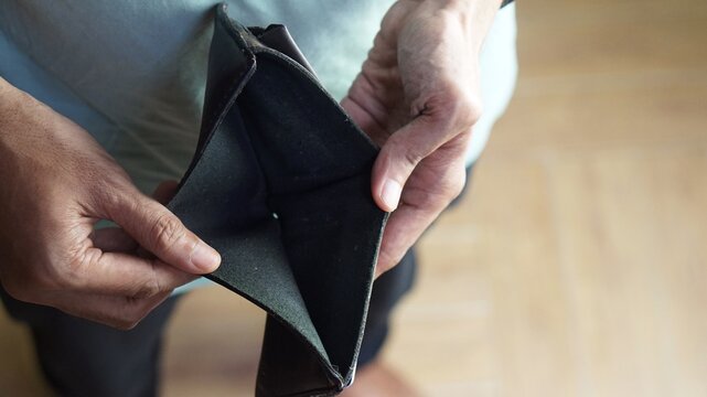 A man is opening an empty wallet