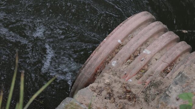 Sewage entering a river. Aquatic polution.