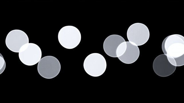 Abstract light bokeh effect with varying circle shapes on a dark background.