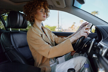 Candid woman driving a car, focused expression, sunlit interior, retro film color vibe, casual...