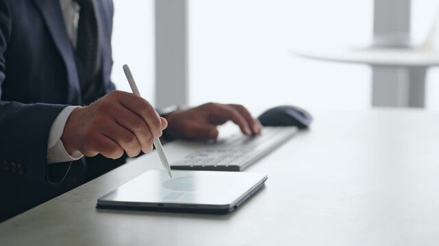 A male business person working using a tablet PC.