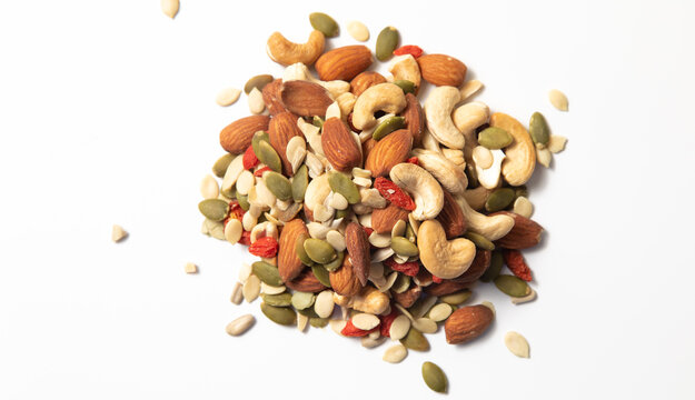 mixed organic cereal and grain seed pile on white background. healthy eating concept. pumpkin, sunflower seeds and legumes.