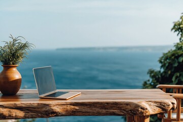 Fototapeta premium Laptop on wooden table with ocean view for remote work nomad tropical sea