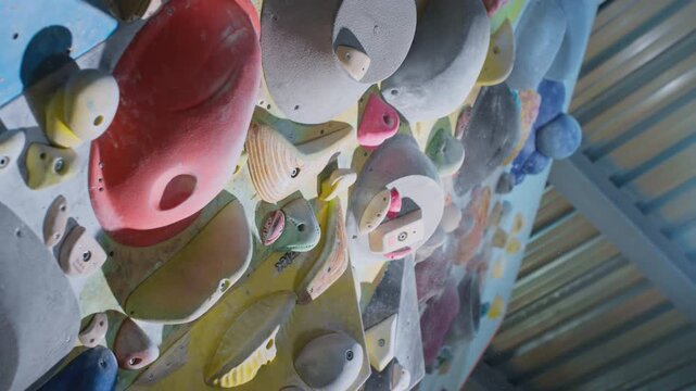 Extreme close-up, hand grabs the ledge, clings to the fingers. Breaks off the ledge, failure. Strong experienced athlete practices bouldering wall climbing inside a gym. Sports lifestyle. Slow motion