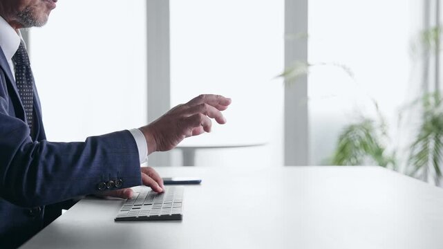 A male businessperson operating a screen in mid-air.