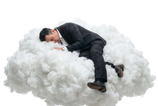 Businessman sleeping peacefully on a fluffy white cloud