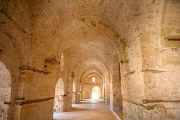 Obraz premium Looking through an ancient defensive loophole window at the sea and city skyline in Alexandria