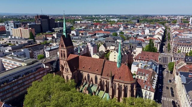 Saint-Pierre-le-Jeune Protestant Church and its cloister in old town of Strasbourg, France. Aerial drone view