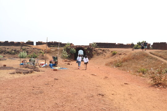 Two girls walking far in Chapora Fort in North Goa, renowned for being featured in the Bollywood movie Dil Chahta Hai.
