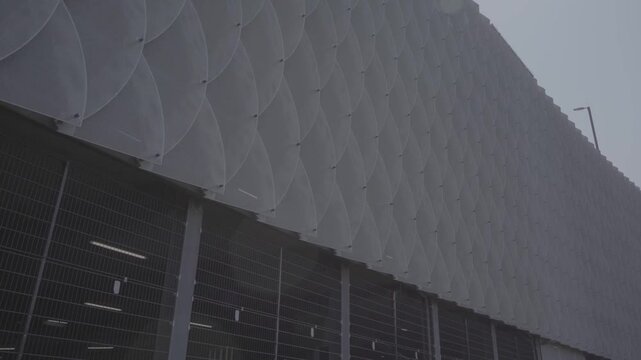 Modern urban parking structure at K&ouml;ln Messe Deutz in Cologne Germany featuring geometric facade design beneath gray overcast sky in metropolitan district area
