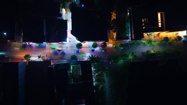 Drone slides sideways above Boracay Highway Central with dense e trike traffic