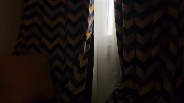 Soft twilight glow filtering through partially drawn drapes into a contemporary bedroom. Serene evening shadows, tranquil home lifestyle vibe, aesthetic B-roll.