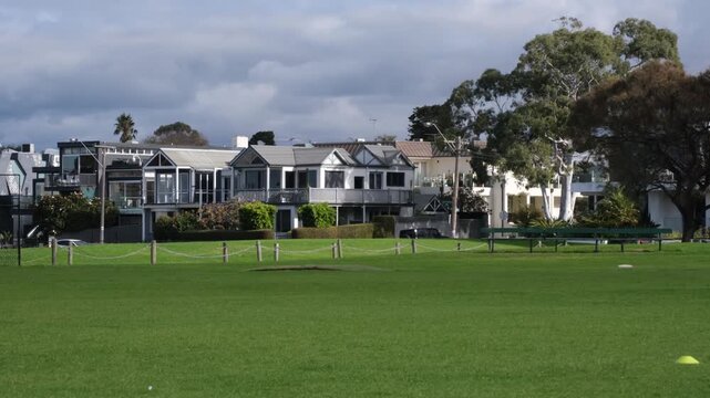 Coastal residential houses overlooking a wide, green public park in the historic bayside suburb of Williamstown, Melbourne, Australia. Luxury homes in a affluent suburb