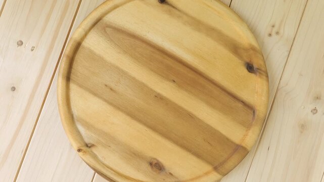 Empty round wooden cutting board turning