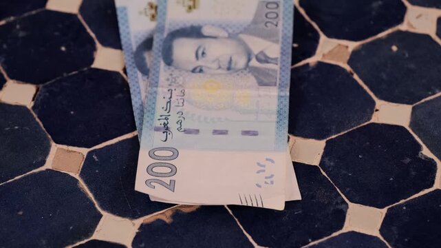 closeup Moroccan dirham money, coins on traditional table, count paper dirham banknotes, cash payments, monetary savings, save for vacation, exchange and cashing currency