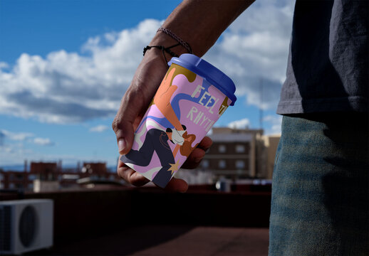 Mockup of Empty take away disposable Cup Held on a Rooftop With Clouds